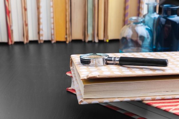 Close-up shot of the Spanish Official State Gazette (BOE) lying on a desk with educational materials such as books and pens; focus on the official seal and title of the Gazette.