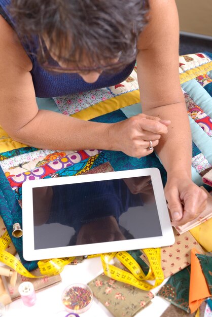 A close-up of a digital tablet displaying an interactive educational app for young children in Spanish, with colorful graphics and an emphasis on playful learning and early literacy skill-building.