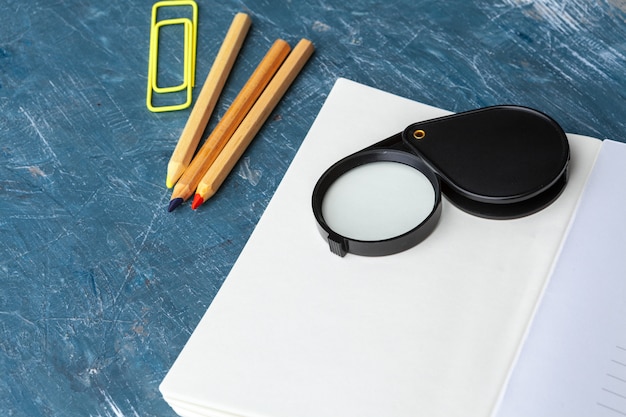 A magnifying glass focusing on an educational document, emphasizing the importance of scrutiny and detailed examination in evaluating educational material.