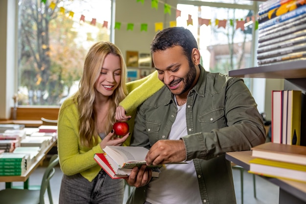 A teacher in Spain guiding a student through an educational guide, providing personalized instruction. The scene shows the interaction between the teacher and the student, emphasizing the importance of personalized support. The background features a well-equipped classroom with learning materials.