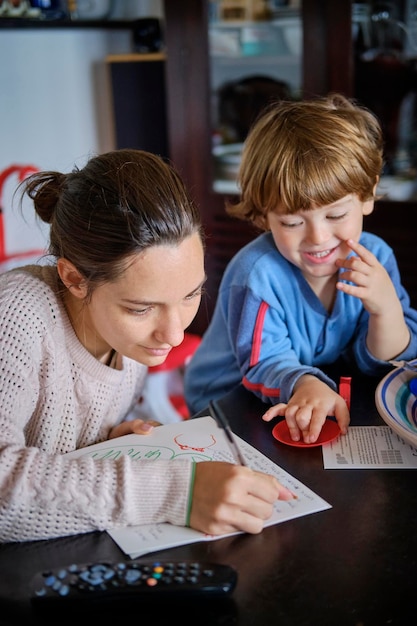 A close-up view of a parent and child reviewing a math textbook together. The child is pointing at an equation, and the parent is smiling encouragingly. The setting is a cozy living room, suggesting an intimate and supportive learning environment. The image emphasizes the importance of family involvement in education and the role of affordable guides in facilitating learning.