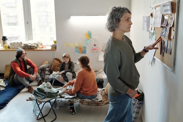 A teacher in Spain guiding a group of students through a critical thinking exercise, using visual aids and interactive discussions.