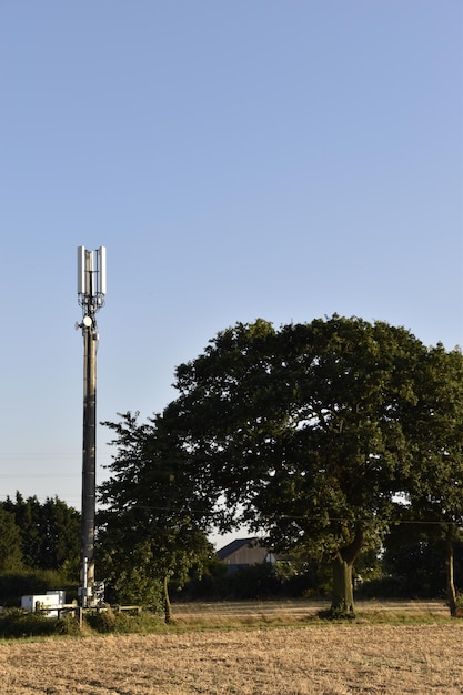 Solar panels in a rural area of Spain, with a 5G tower in the background, illustrating the use of 5G in smart energy management and renewable energy integration.
