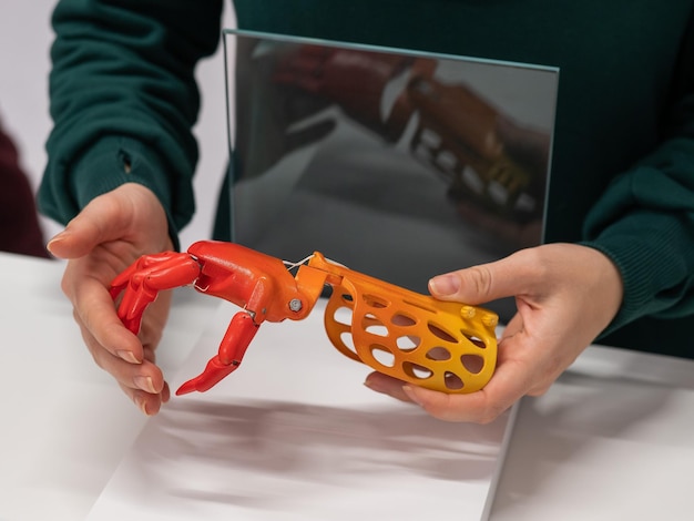 A doctor examining a 3D printed replica of a patient's organ or bone structure. The doctor is using a caliper or other measurement tool to inspect the model, highlighting the role of 3D printing in pre-surgical planning and precision medicine.