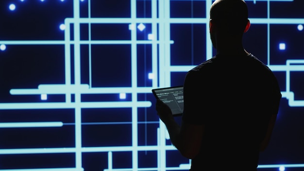 A cybersecurity professional analyzing a network security breach on a computer screen, with lines of code and warning signs displayed. Emphasis on the urgency and complexity of addressing cyber threats.