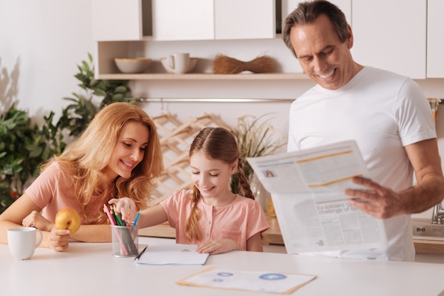 An image displaying a family looking at financial documents, highlighting the importance of understanding child benefits and financial planning.