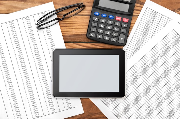 A close-up on a calculator with financial documents in the background. The calculator displays a retirement savings calculation, emphasizing numbers and symbols related to pension amounts and interest rates.
