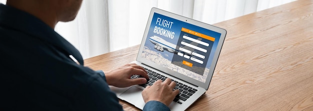 A person using a laptop to fill out an online application form, with a focus on the screen displaying the rental assistance application and required fields.