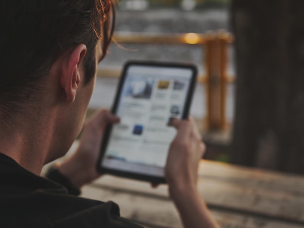 A person using a smartphone to access a digital platform displaying information about various social benefits and services available to them. The app interface is user-friendly, with clear icons and easy navigation.