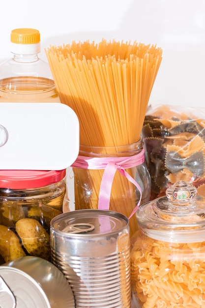 A close-up shot of various essential food items, such as rice, pasta, canned goods, and oil, neatly arranged in a food basket, symbolizing the contents of a typical food distribution package provided by the program.