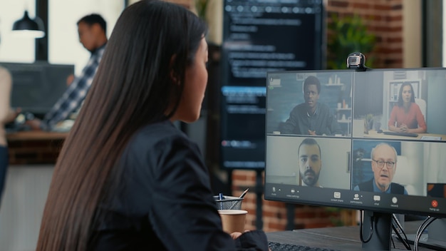 A split screen image showing a team of Spanish IT professionals on one side and a team of Japanese IT professionals on the other, collaborating via video conference on cybersecurity compliance issues.