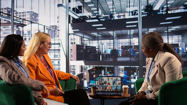 A high-tech office environment with a diverse team of professionals collaborating around a large interactive screen displaying data analytics and charts. The office features modern furniture, glass walls, and plenty of natural light, creating an atmosphere of innovation and productivity.