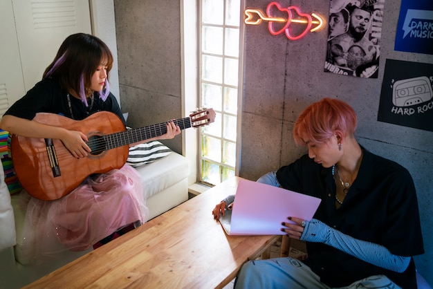 A split image showing on one side Spanish artists collaborating with K-Pop groups in a recording studio, and on the other side, Spanish record labels implementing K-Pop style marketing strategies like pre-order campaigns and merchandise sales.