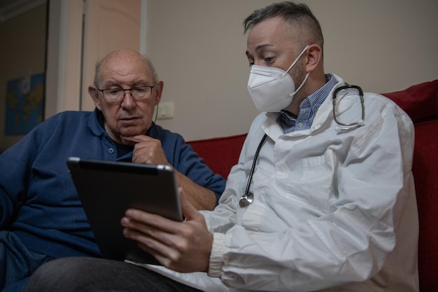 A close-up shot of a Spanish doctor consulting with an elderly Japanese patient using a telemedical device. The scene conveys trust, technological integration, and cross-cultural collaboration.