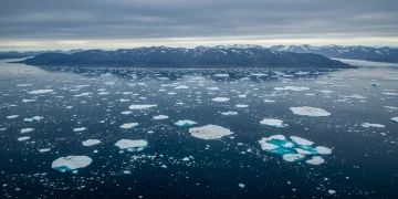Vast Arctic landscape with ice, water, and mountains