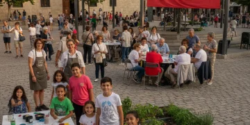 Grupo diverso de ciudadanos españoles participando activamente en un evento comunitario, simbolizando la cohesión social y la educación cívica.